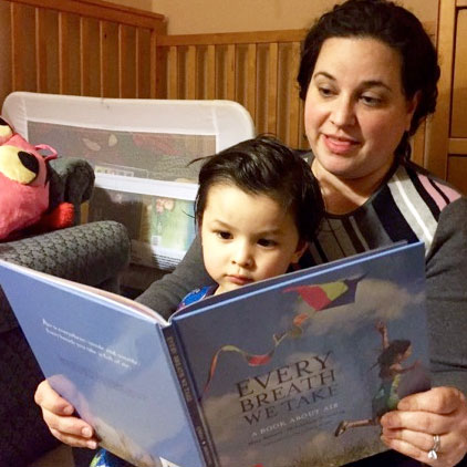 Mother reading Every Breath we Take to child
