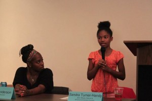 Woman and young girl discussing Detroit Incinerator
