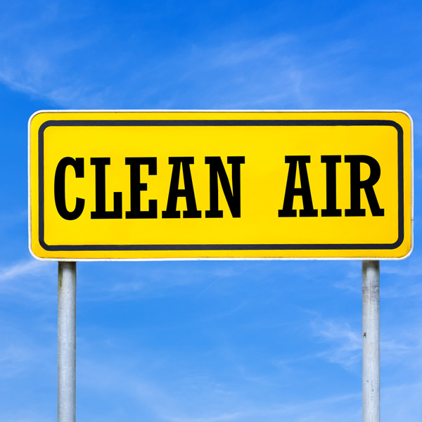 Yellow clean air sign against blue sky background