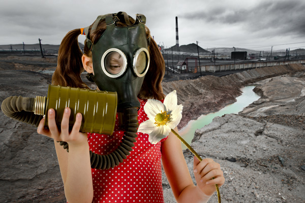 Girl wearing gas mask and holding a flower