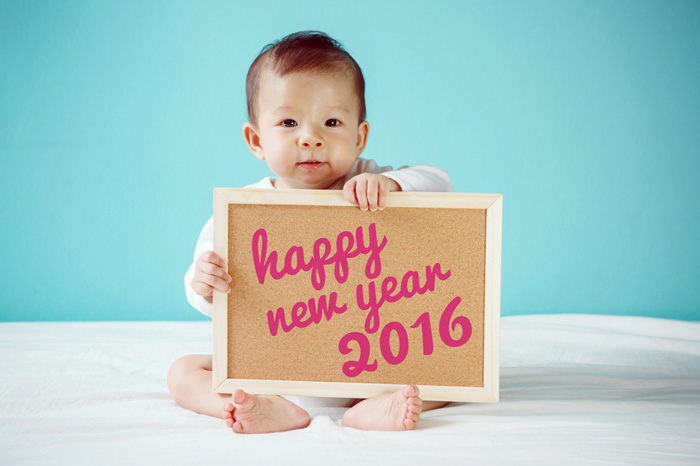 Baby holding happy new year sign