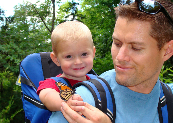 Dad and baby with a monarch butterfly