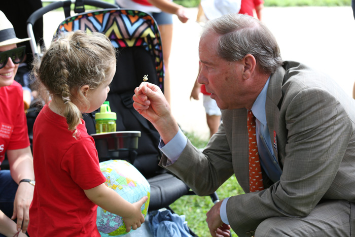 After receiving a tiny white flower from Play-In participant, Kira, Senator Tom Udall (NM) thanked Moms for Clean Air and said, "Taking action on climate change is important to me. It's important to all of us here. It may be the biggest man-made threat that we face."