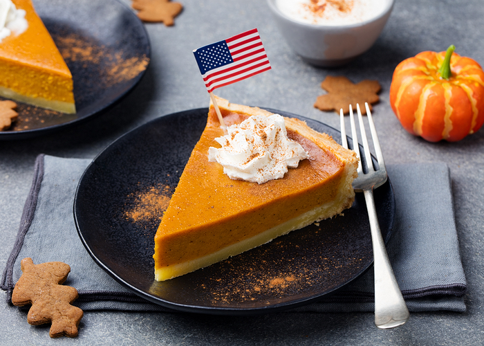 Slice of pumpkin pie with a flag in it