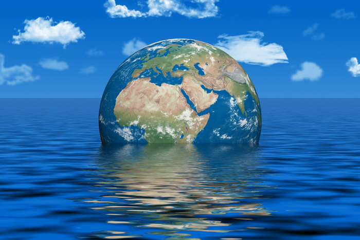 Globe floating in water under blue sky