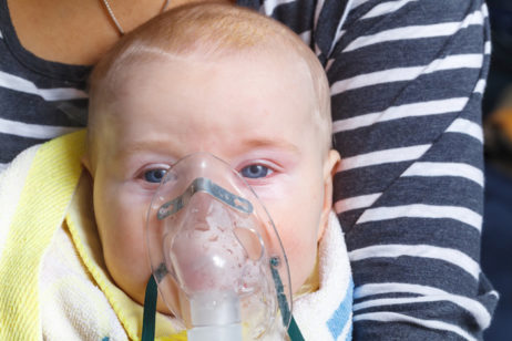 Baby wearing oxygen mask
