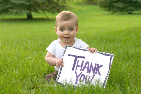 baby holding thank you sign