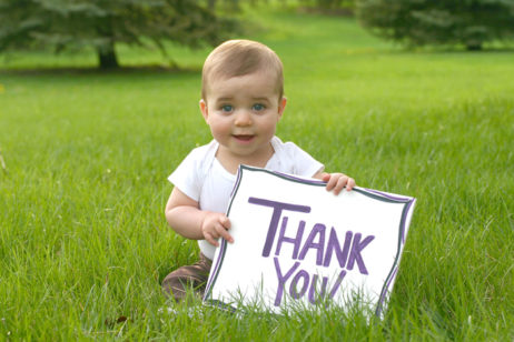 baby holding thank you sign