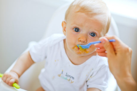 baby being spoon fed baby food