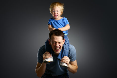 child sitting on dad's shoulders