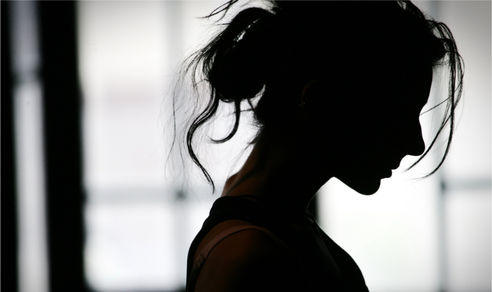 Silhouette of a sad woman, possibly suffering from intense stress