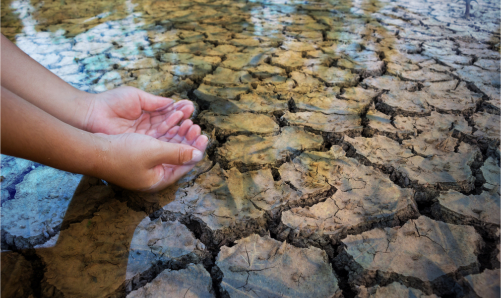 hands in shallow water that may disappear due to drought