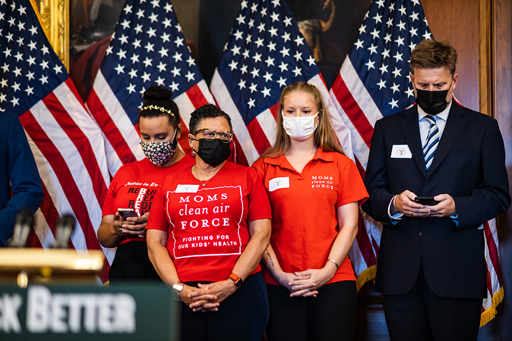 Moms Clean Air Force members stand with Speaker Pelosi to support the Build Back Better Act