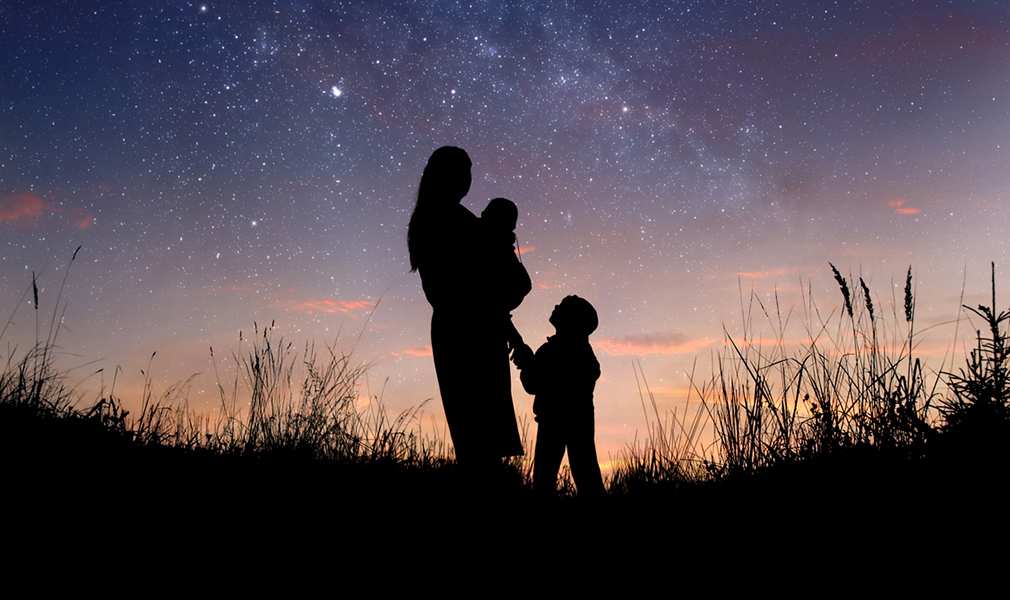 Mom and kids all look up at the night sky