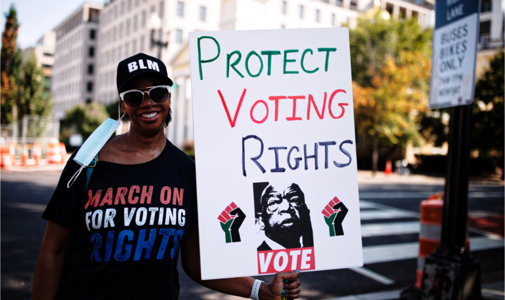 Woman holding sign that reads Protect Voting Rights