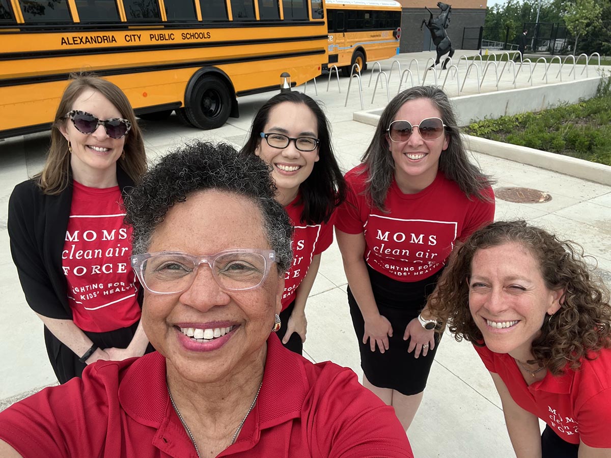 Moms Clean Air Force Team members celebrating the new investment in electric school buses.