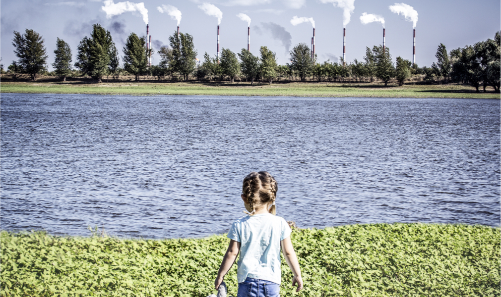 A child across the water from air pollution producing factories. Cancer patients are more susceptible to harm from air pollution