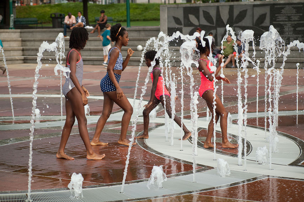 Children playing in a splash park, one of the ways to cope with extreme heat