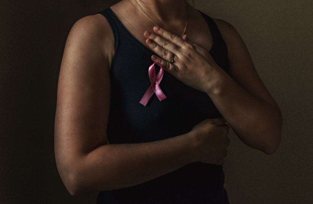 Woman wearing breast cancer awareness pink ribbon.