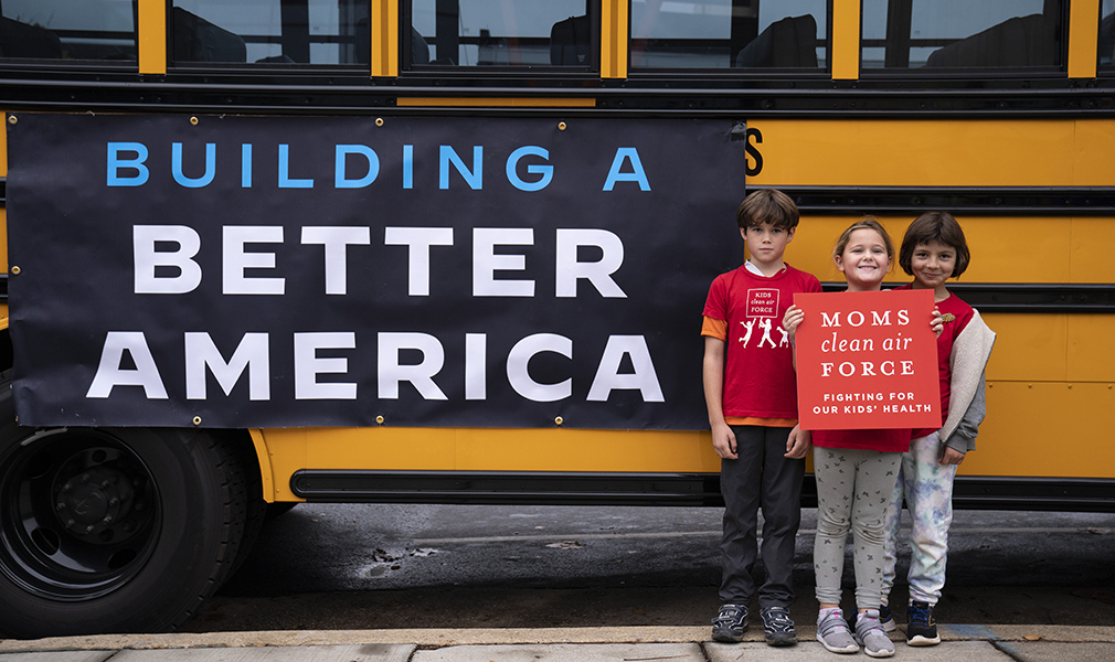 Clean Air Kids with one of the new electric school buses in Washington, DC. Photo by Sarah Silbiger for Moms Clean Air Force.