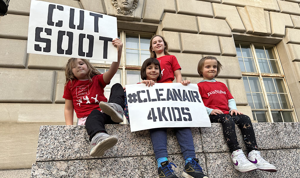 Kids holding signs for EPA to strengthen soot protections