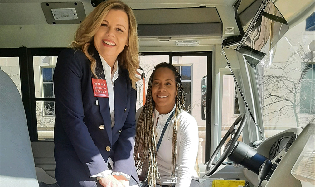 Moms Michigan Organizer Elizabeth Hauptman with Supermom Robin Gamble in an electric school bus during at event at the State Capitol in Lansing, October 2022.