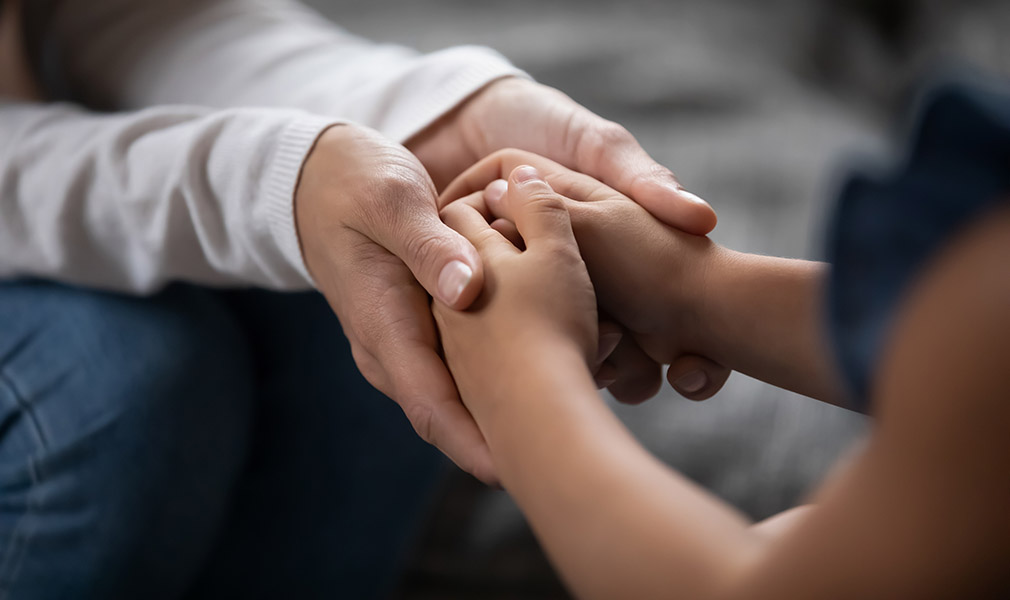 Parent and child holding hands