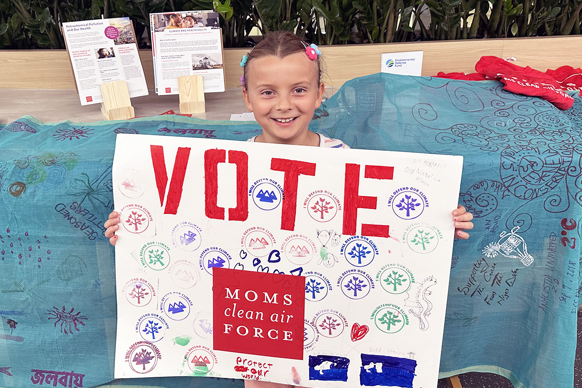 child holding vote sign