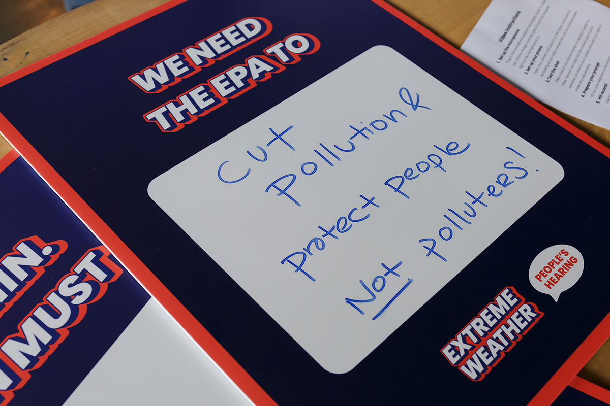 Sign at the Extreme Weather People’s Hearing protesting the Trump EPA environmental attacks