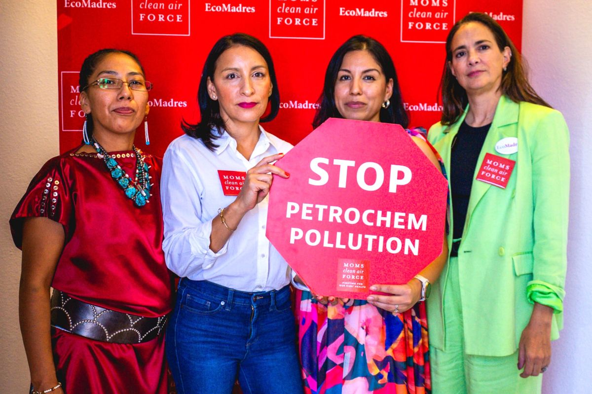 Moms members holding Stop Petrochemical Pollution sign