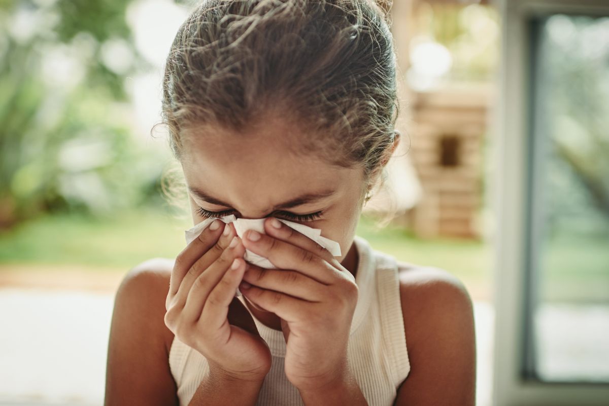 child blowing nose