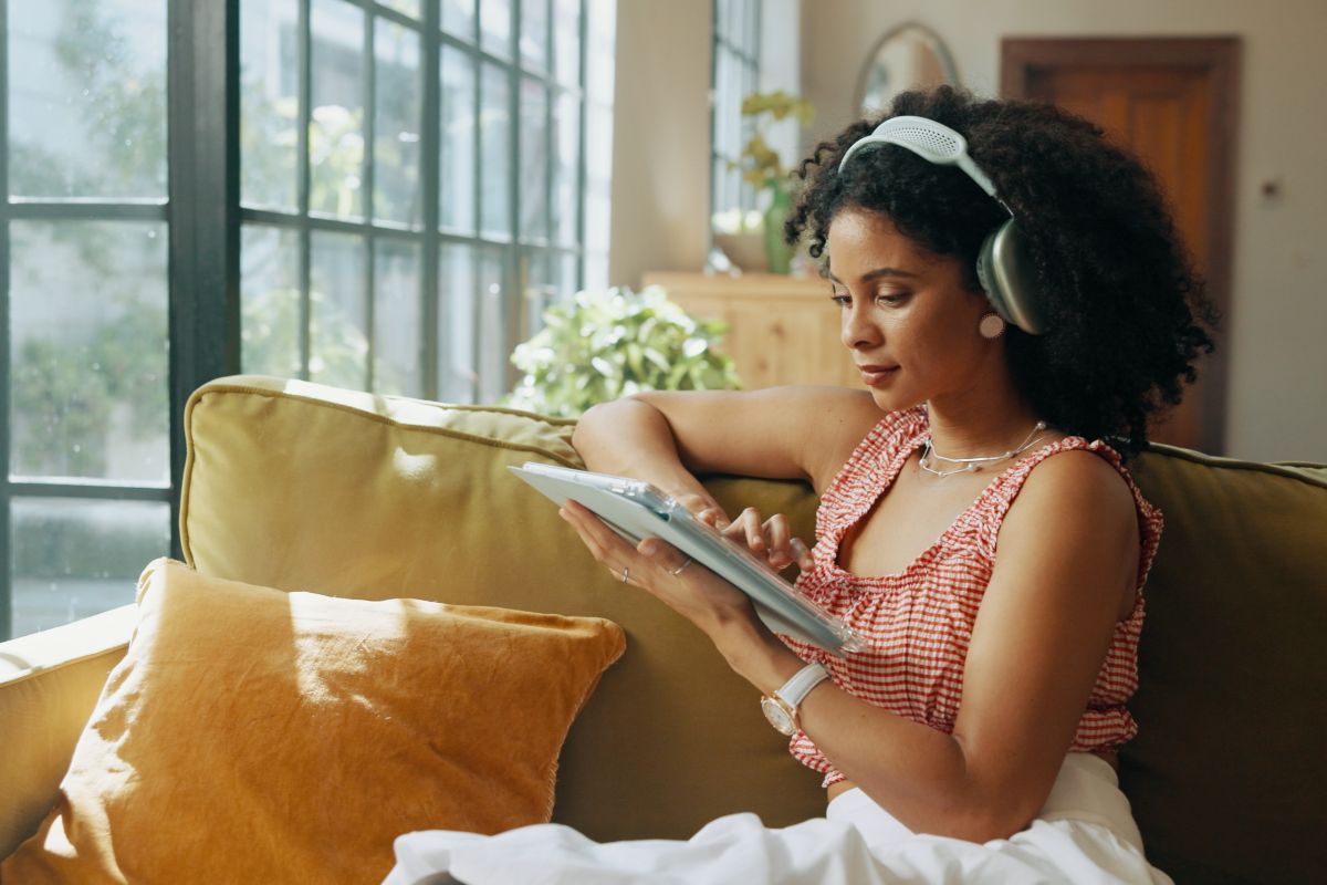 woman with tablet and headphones