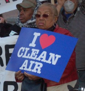woman holding a I heart clean air sign