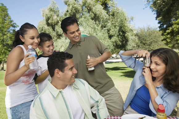 Latino family enjoying a picnic outside