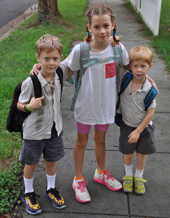 Three children with backpacks