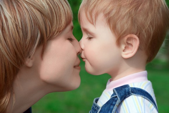 Mother touching noses with son