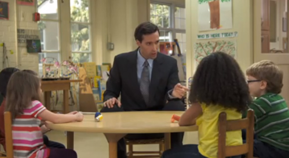 Screenshot of clean air ad, man sitting at a table of kids asking them a question 