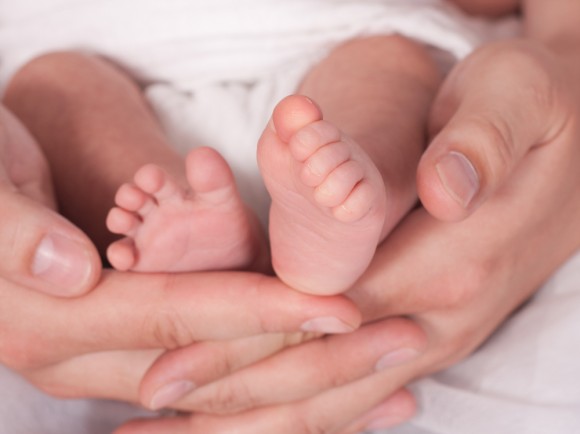 Baby feet in mom's hands