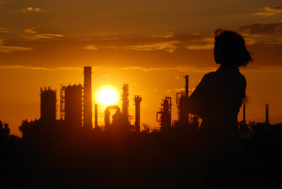 Woman in front of cement plant questioning cement standards