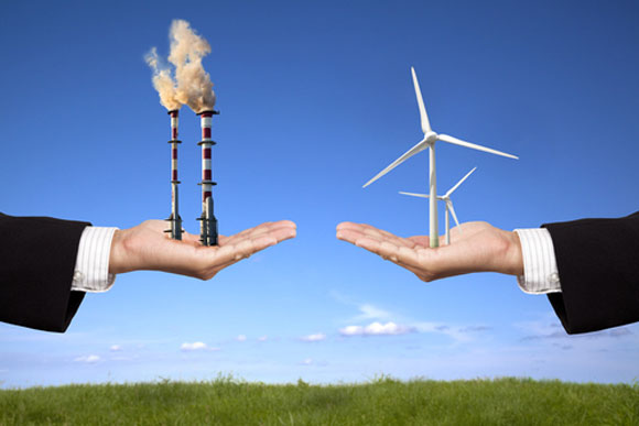 Mens hands holding a smokstack and a wind turbine