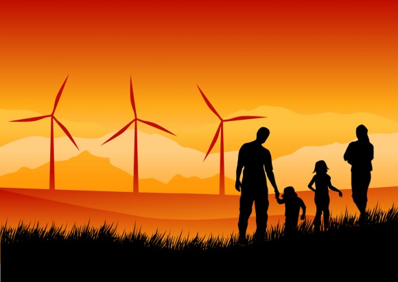 Family of 4 sihouetted against orange sky with wind turbines