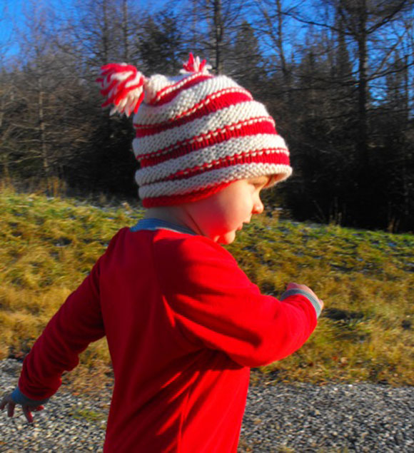 Little boy in red and white striped hat
