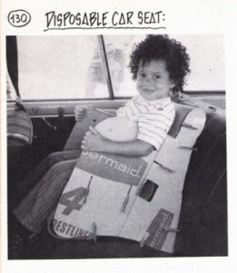 toddler sitting in a disposable, cardboard car seat