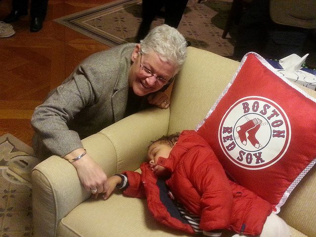 EPA Administrator Gina McCarthy poses with a young girl asleep on her couch