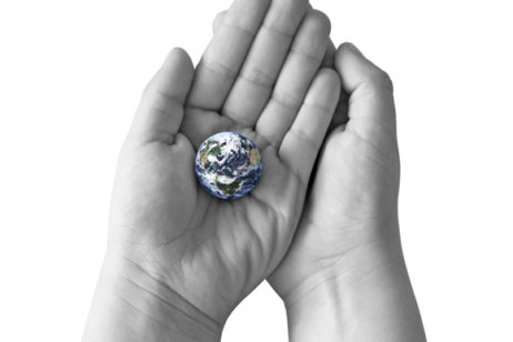 hands holding a tiny globe