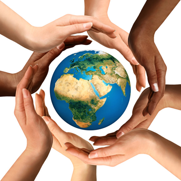 hands of different ethnicity circle a globe 