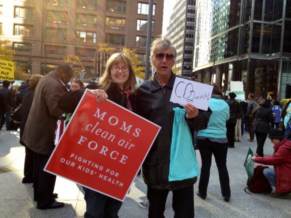 Wendy Bredhold holding a Moms Clean Air Force sign at the EPA listening session on carbon pollution in Chicago