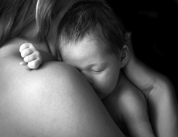 Baby sleeping on moms's shoulder