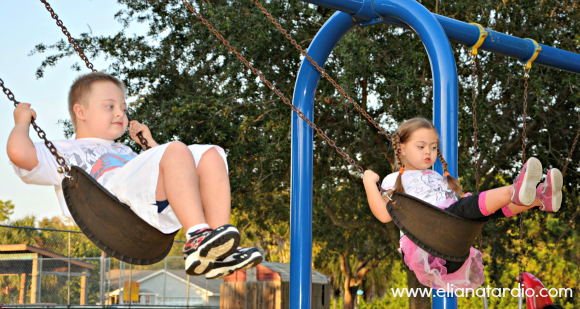 Two children swinging