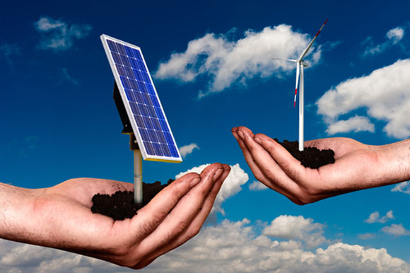 Solar panel and wind turbine held in hands